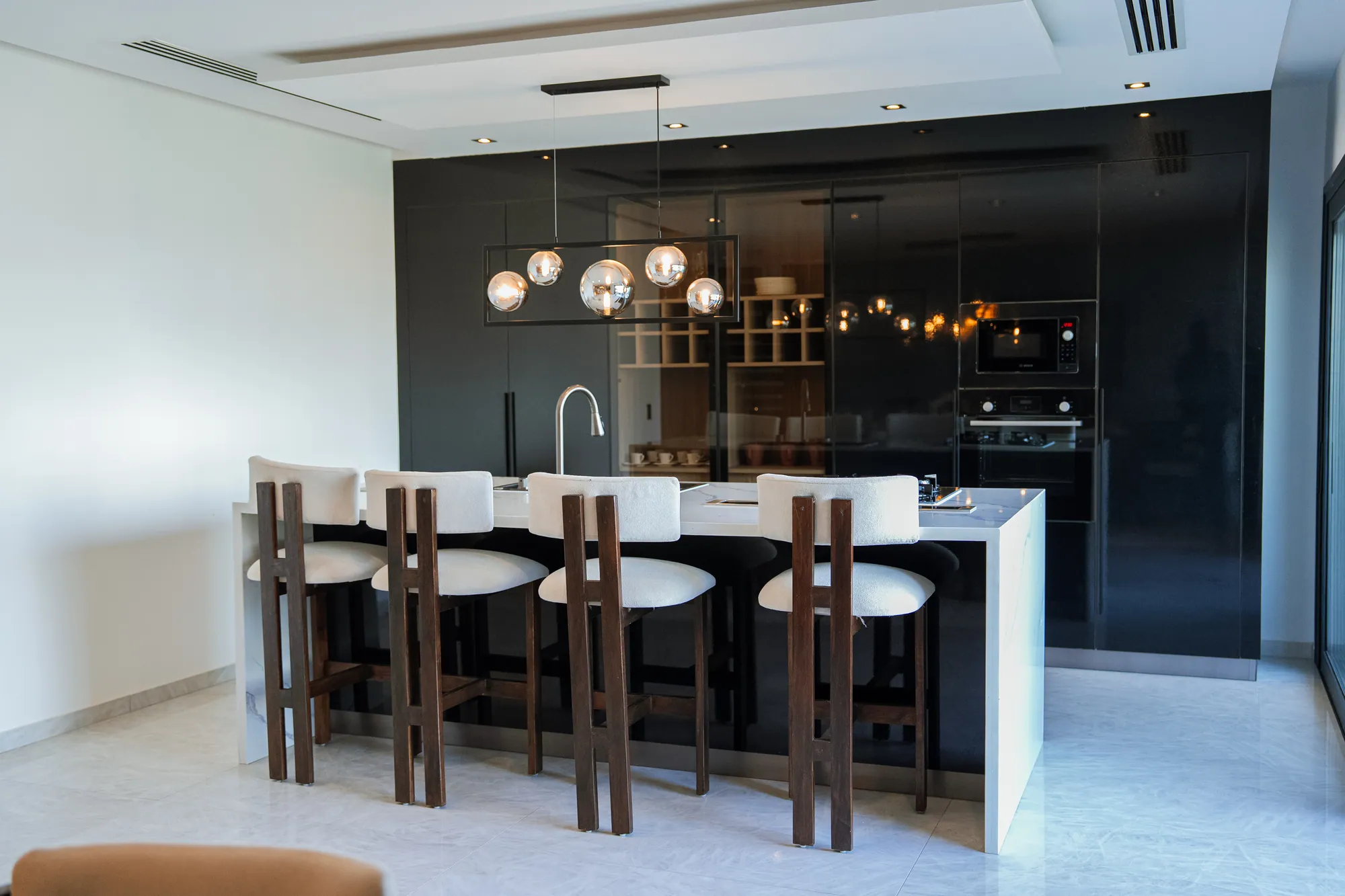 Cuisine en laque noire et îlot central d'un duplex SMCI